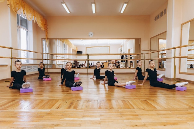 A group of girls doing gymnastics doing gymnastic
exercises.