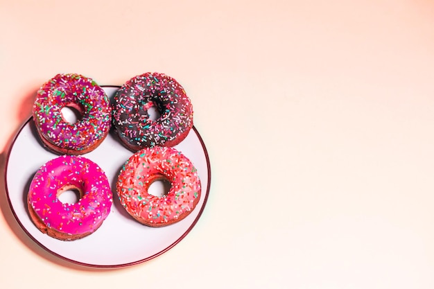 Group of glazed donuts on light background, copy space