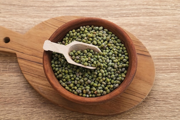 Group of green mung beans served on wooden bowl on wooden background