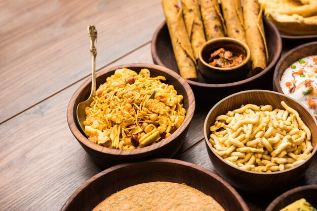 Group of Gujarati snacks like jalebi-fafda, thepla, khaman dhokla, aloo bhujiya, khandvi,khakra, dahi vada, gathiya with hot tea