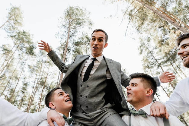 Group of guys having fun and having a full blast, funny people, happy guys, young groom, wedding day