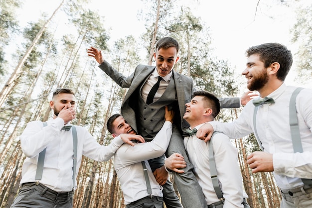 Group of guys having fun and having a full blast, funny people,
happy guys, young groom, wedding day