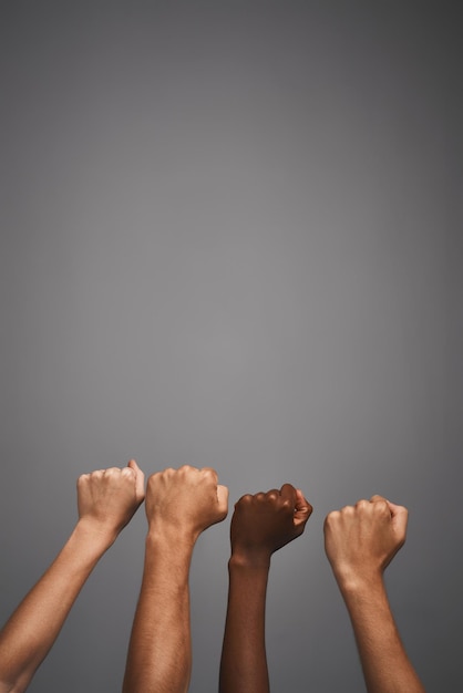 group hands or fist in studio with unity for protest freedom or human rights power on mockup space collaboration people or sign for support with equality solidarity or justice on gray background