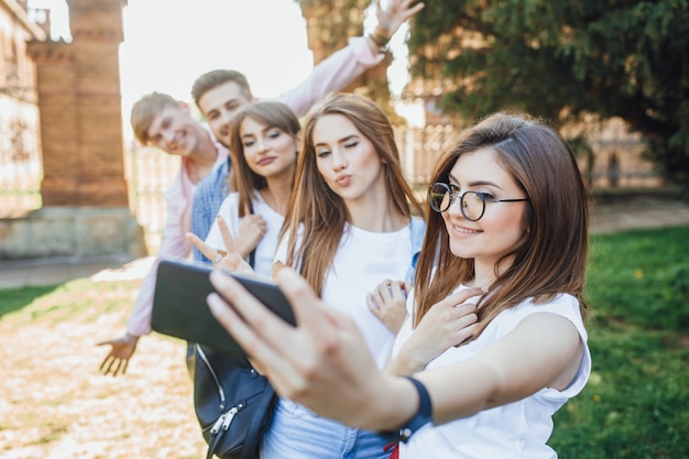 A group of handsome young people doing a selfie in a campus.