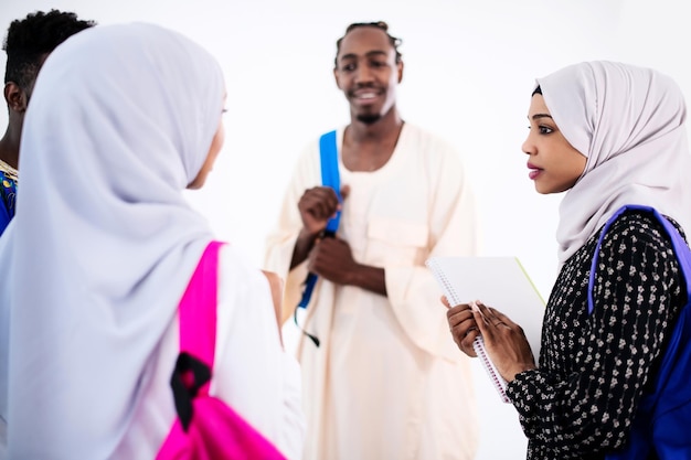 group of happy african students having conversation and team meeting working together on homework girls wearing traidiional sudan muslim hijab fashion