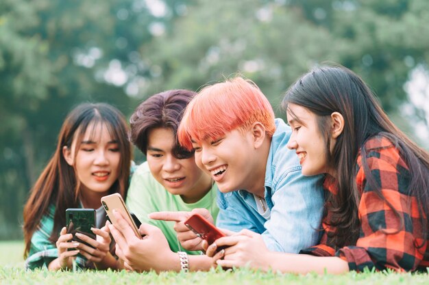 Group Of Young Asian People Sitting And Addicted To Playing Mobile