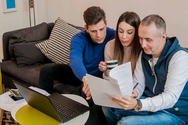 Group of happy business people in a meeting at home office. Confident team of engineers working together. Team of happy office people reading document