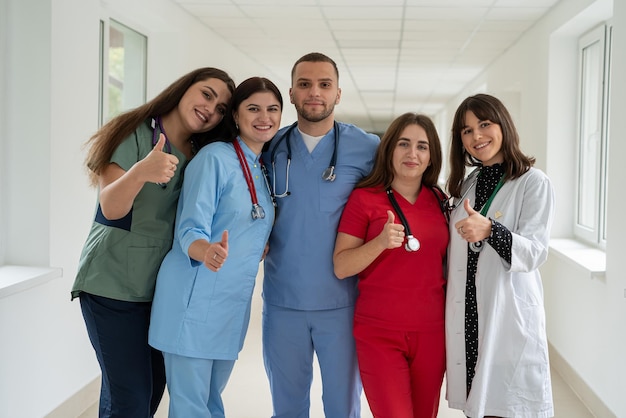 Group of happy caucasian intern students in college hallway