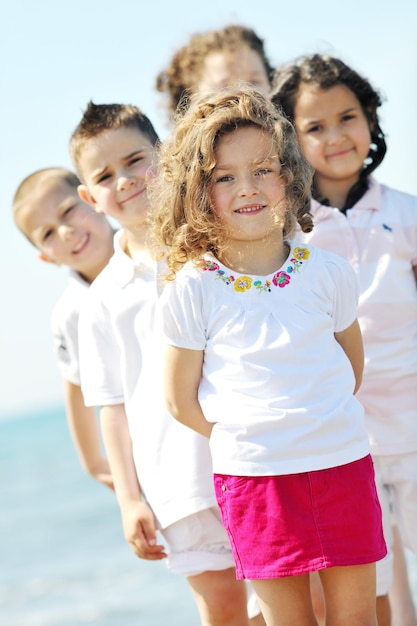 group of happy child on beach who have fun and play games