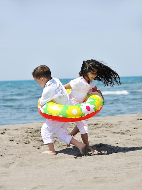 group of happy child on beach who have fun and play games