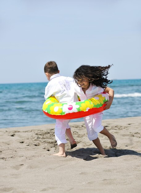 group of happy child on beach who have fun and play games