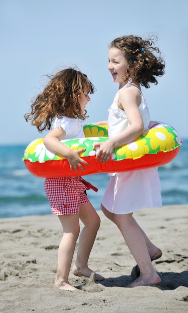 group of happy child on beach who have fun and play games