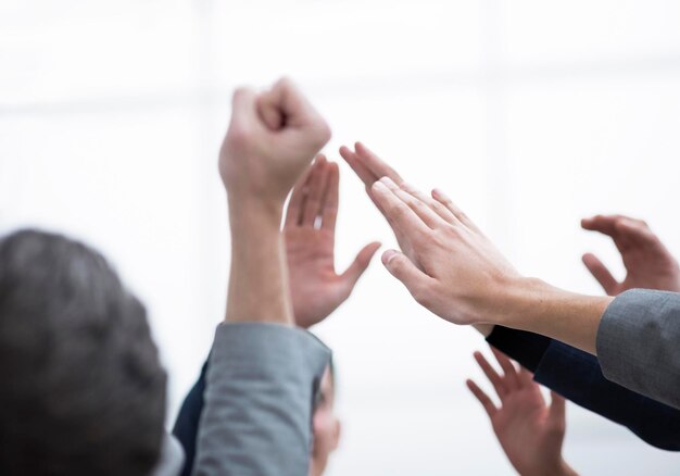 Group of happy employees giving each other a high five