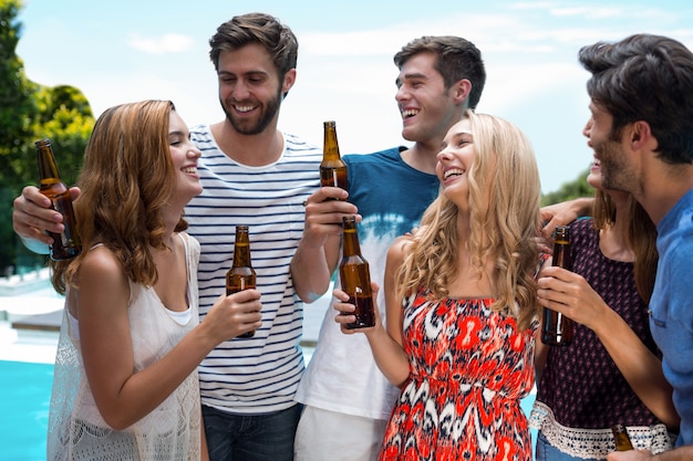 Group of happy friend holding beer bottles