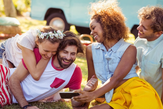 Group of happy friend using mobile phone