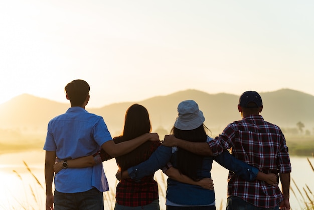 Group of happy friends are raised arms together,  Friendship happiness concept.