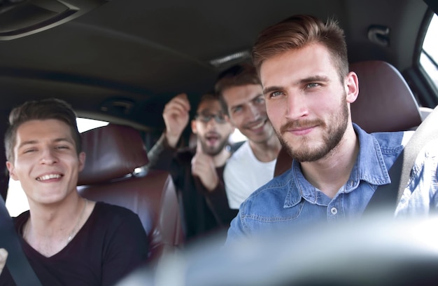 Group of happy friends on a car