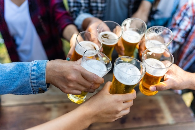 Group of happy friends living healthy lifestyle and relax Cheering with beer and And Drinking Beer