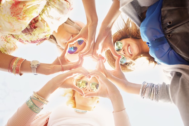 Photo group of happy friends showing hearts