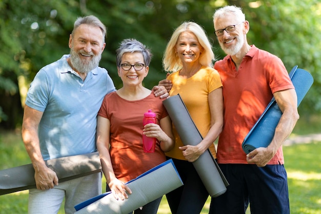 Group of happy senior people practicing sport together outdoors