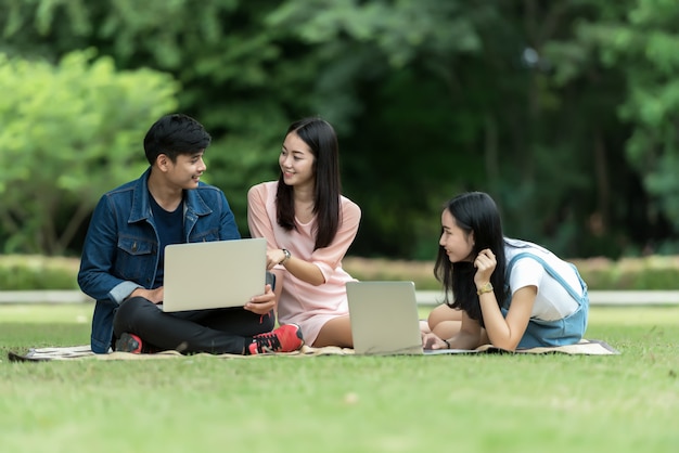 Group of happy teen high school students outdoors