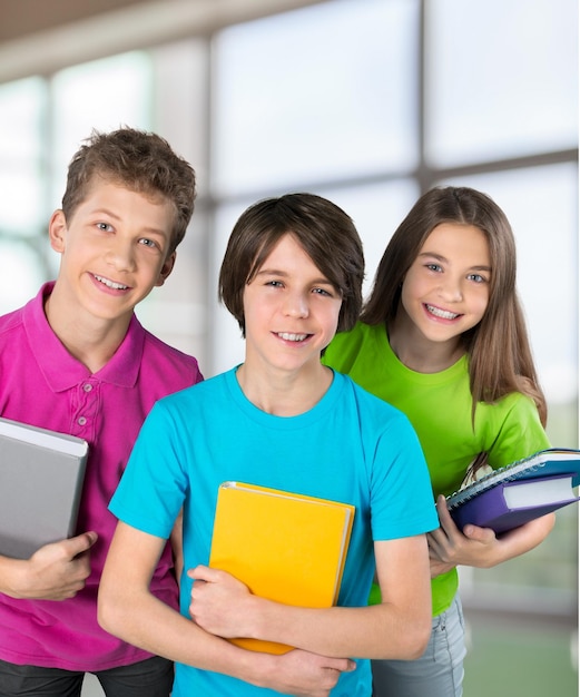 Group of happy teen school child with book.  Isolated.