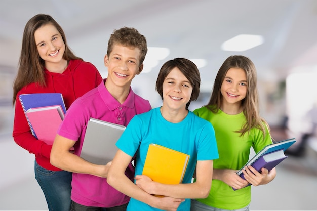 Group of happy teen school child with book.  Isolated.