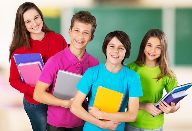 Group of happy teen school child with book Isolated