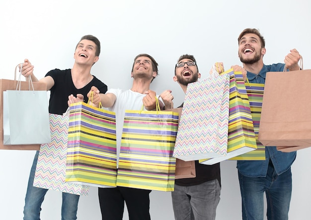 Group of happy young friends with shopping bags photo with copy space