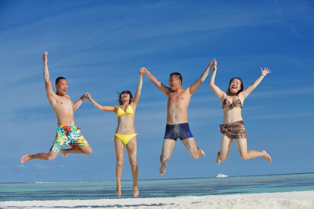 group of happy young people have fun and joy at the  white sand  beach on beautiful summer  day