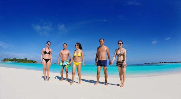 group of happy young people have fun and joy at the  white sand  beach on beautiful summer  day