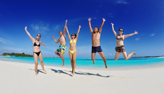 group of happy young people have fun and joy at the  white sand  beach on beautiful summer  day