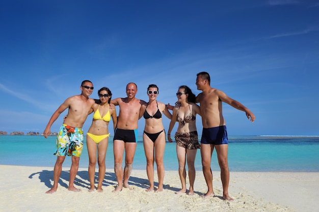 group of happy young people have fun and joy at the  white sand  beach on beautiful summer  day