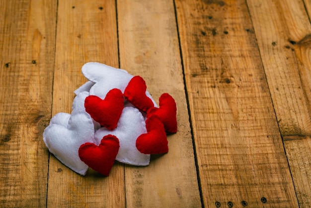 Group of hearts made of felt on wooden table  Valentines day background