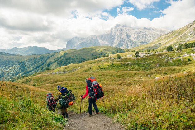 Group hiking in the Mountains of Republic of Adygea with large backpacks Russia