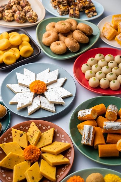 Group of Indian assorted sweets or mithai with diya