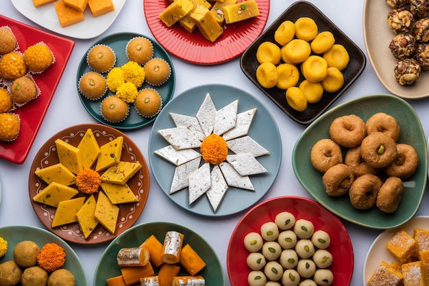 Group of Indian assorted sweets or mithai with diya