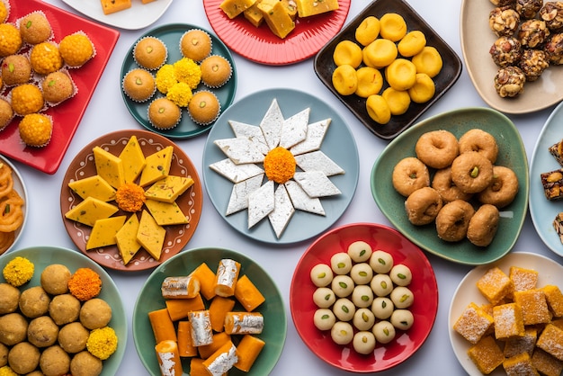 Group of Indian assorted sweets or mithai with diya