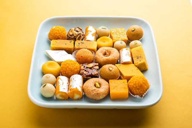 Group of Indian assorted sweets or mithai with diya