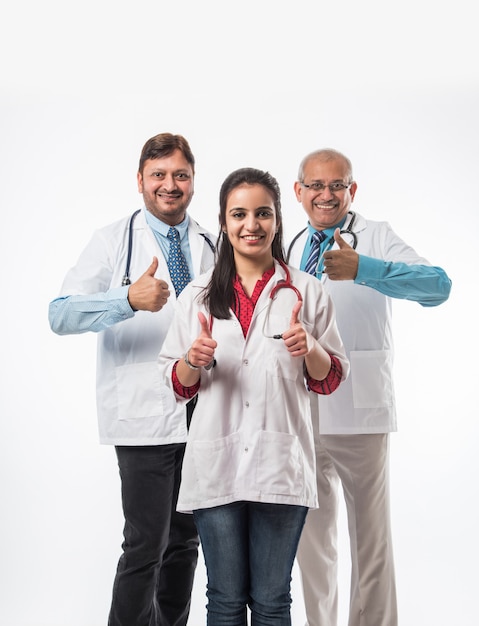 Photo group of indian medical doctors, male and female standing isolated on white background, selective focus