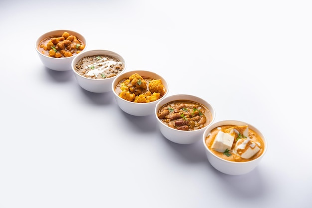 Group of Indian vegetarian dishes hot and spicy Punjabi cuisine meal assortment in bowls