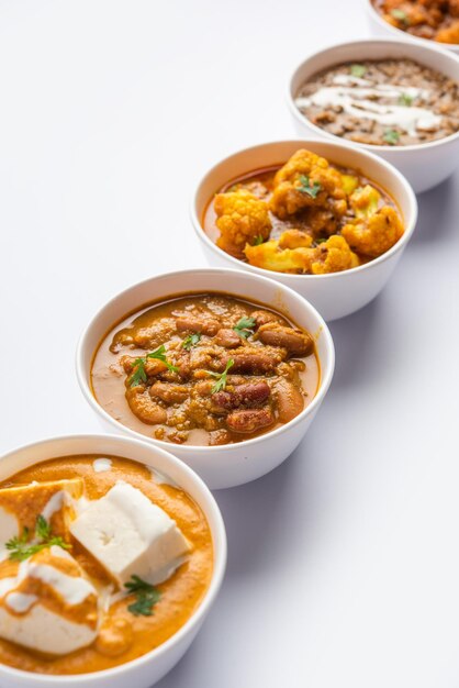 Group of Indian vegetarian dishes hot and spicy Punjabi cuisine meal assortment in bowls