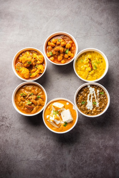 Group of Indian vegetarian dishes hot and spicy Punjabi cuisine meal assortment in bowls