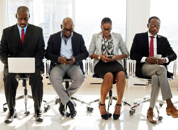 Photo a group of international business people are sitting and using wireless devices