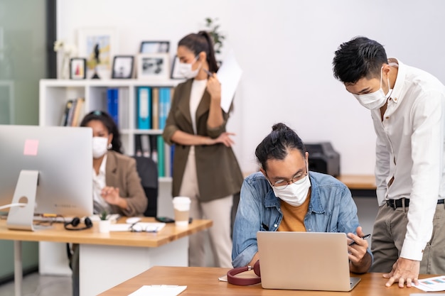 Group of interracial business worker team wear protective face mask in new normal office