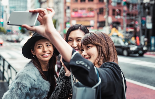 Group of japanese women spending time in Tokyo, making shopping in differents areas of the city