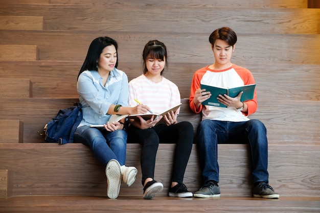 Group of junior and senior asian students tutoring lesson with their lecturer, education concept