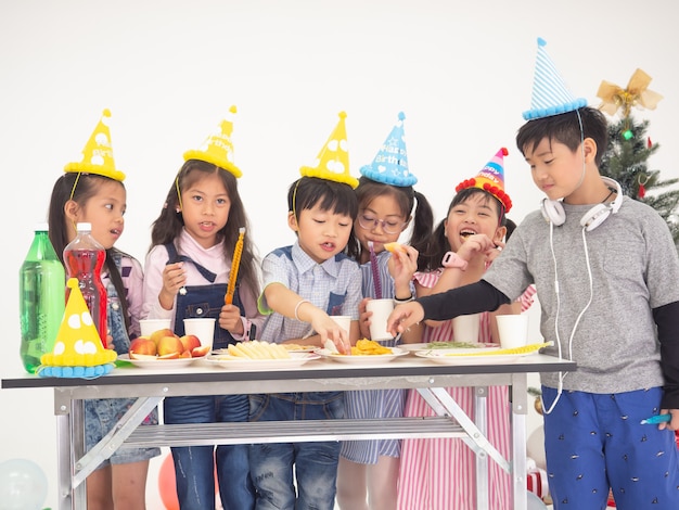 Group of kids celebrate party and enjoy christmas fun together,Children are exchanging gifts.