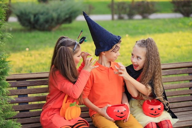 Group of kids in costumes for halloween in the park