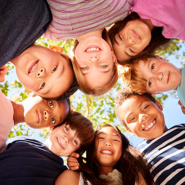 group of kids outdoors looking down at camera square format